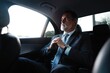 © opolja - Mature handsome businessman is sitting in luxury car. Serious bearded man in suit.