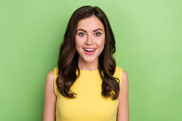 Wall Mural - Portrait of attractive amazed sincere cheerful wavy-haired girl wow reaction isolated over bright green color background