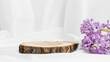 Round empty wooden podium with spring hyacinth flowers on white textile, display to product, perfume and cosmetics presentation