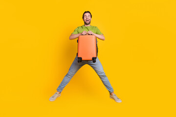 Poster - Full length photo of young man jump hold bag tourist flight abroad journey isolated over yellow color background