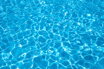  Flat view swimming pool background.Blue water in swimming pool background.Sun glare on the water,travel background