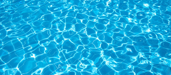 Flat view swimming pool background.Blue water in swimming pool background.Sun glare on the water,travel background