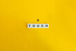 © photoopus - Touch Word on Letter Tiles and Fingertip Icon on Yellow Background. Minimal Aesthetics.