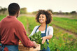 © Nikish Hiraman/peopleimages.com - Here you go. Cropped shot of an attractive young female farmer passing a crate of fresh produce to her husband.