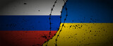 Grunge flags of Russian Federation and Ukraine divided by barb wire illustration.