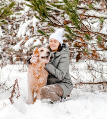 Wall Mural - Golden retriever dog with girl in winter time