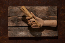 Wooden Hand With Pestle On Cutting Board