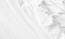 White Untidy Duvet On The Bed. Soft Bedsheet Top View Background. Comfortable And Luxury Room. Hotel And Resort Accommodation. Blanket For Relaxation. Cozy Fabric Backdrop.