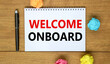 Welcome onboard and support symbol. Concept words Welcome onboard on white note. Metallic pen. Beautiful wooden background. Copy space. Business and Welcome onboard concept.