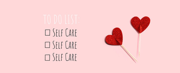 self care - to do list with red glitter heart picks - flat lay