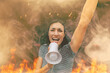© Carlo - woman protesting shouting slogan into megaphone amidst smoke and flames - riotous young woman