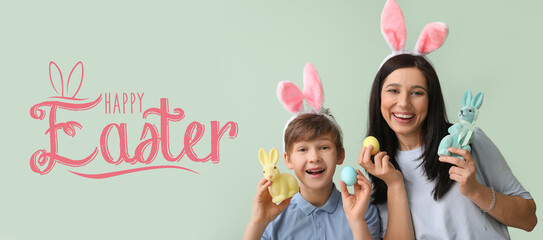 Canvas Print - Little boy and his mother with Easter eggs and bunnies on grey background