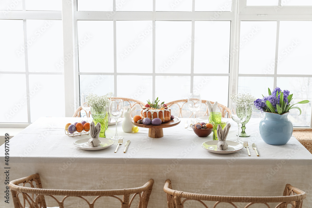 Easter cake and eggs on served dining table in light room