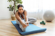 © Louis-Paul Photo - African american woman working out in home livingroom gym