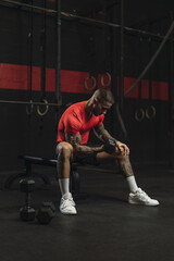 Wall Mural - Strong muscular European guy with cool tattoos working out in a gym