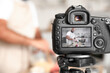 © Pixel-Shot - Handsome man making dough on display of photo camera in kitchen, closeup