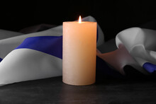 Burning Candle And Flag Of Israel On Dark Background. Holocaust Remembrance Day