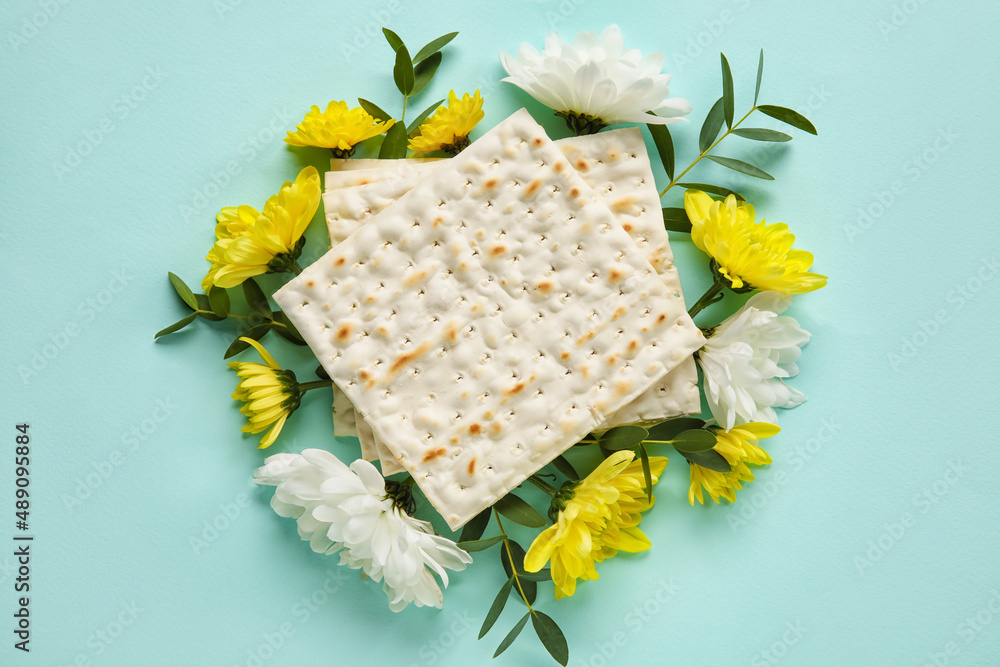 Jewish flatbread with flowers on color background