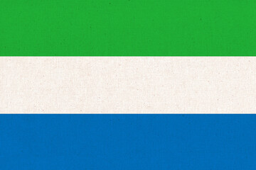 Sierra Leone national flag on patterned background. Fabric Texture