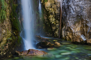 Grunas waterfall 2 km behind the village of Theth in Albania. Theth is a small village in Shkodër county in Albania. It is a protected landscape area