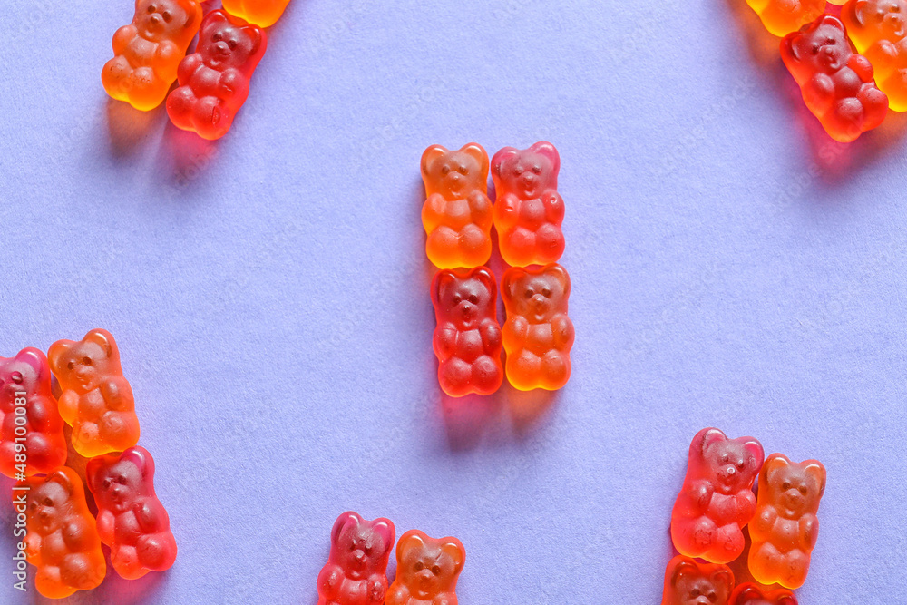 Sweet jelly bears on blue background, closeup