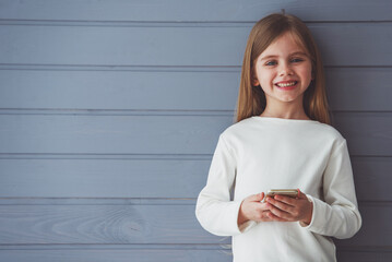 Wall Mural - Little girl with gadget