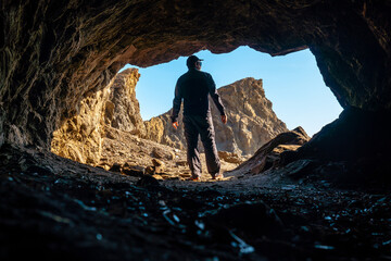 Wall Mural - A young tourist in the Almanzora caves, Cala Peñon cut off a virgin and hidden beach in Almería. Mediterranean sea on the coast, Almería