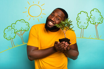 Wall Mural - Man holds and takes care of a small tree
