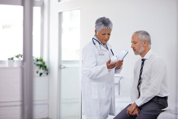 Canvas Print - These should help a lot. A mature doctor giving a bottle of pills to one of her patients during a checkup.