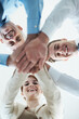 © Nicola K/peopleimages.com - Lets do this. Portrait of a group of business people standing in a huddle.