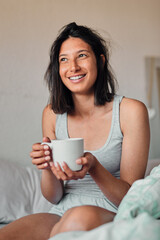 Sticker - I cant wait to see what this day will bring. Shot of a young woman enjoying a relaxing cup of coffee in bed at home.