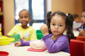 Getting some energy for the fun activites ahead. Pre-school children on their lunch break eating sandwiches.