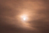 Fototapeta Zachód słońca - The sun behind the smoke. City smog.