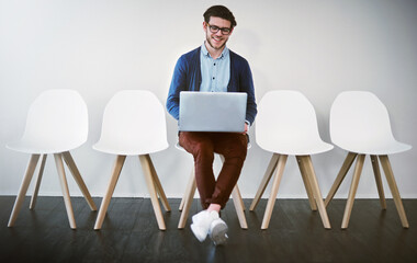Aufkleber - Im well prepared, thanks to the internet. Shot of a young businessman using a laptop while waiting in line.