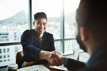 Aufkleber - Its safe to say he made a great impression. Shot of two young businessmen shaking hands while sitting at a desk in a modern office.