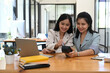 © Prathankarnpap - Two young woman customer swiping a credit card through through terminal for payment at coffee shop.