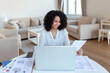 © Graphicroyalty - Business professionals. Business woman analyzing data using computer while spending time in the office. Beautiful young grinning professional Black woman in office. Graphs and charts