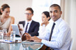 © Tasneem H/peopleimages.com - Hes got technology on his side. Portrait of an happy businessman using his laptop in the office.