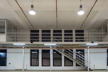 Interior of a large industrial space with mezzanine at night