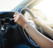 © Lyndon S/peopleimages.com - On route to her destination. Closeup shot of a woman holding onto a steering wheel while driving.