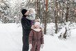 © Svetlana Repnitskaya - father with two daughters walking through the winter forest