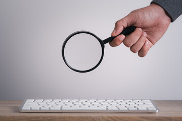 Wall Mural - man's hands are using a computer keyboard to searching for information. using search console with yo