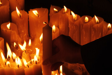 Lighting candles in chapel of Our Lady from the Kamenita vrata (Stone Gate) in Zagreb to remember and honor the deceased loved ones