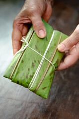 Native woman cooking typical Colombian and Mexican traditional dish called tamal.