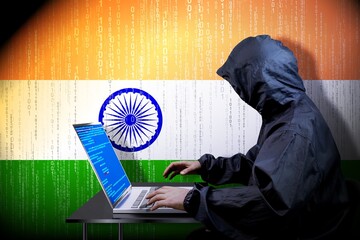 Anonymous hooded hacker, flag of India binary code - cyber attack concept