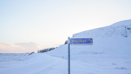 Poster - Snowy landscape view of white snow land and a white sky with kleifar sign in Iceland