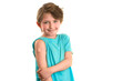 © Ruslan Russland - a happy boy showing his arm with  bandage after got vaccinated. A emotional child with a band-aid on his hands, vaccinated against a coronavirus infection. Vaccination against COVID-19