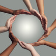 © Adene Sanchez/peopleimages.com - Coming together to form one. Cropped shot of a group of hands linking together to form a circle against a grey background.