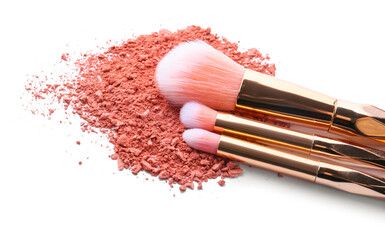 Makeup brushes and loose eye shadow on white background