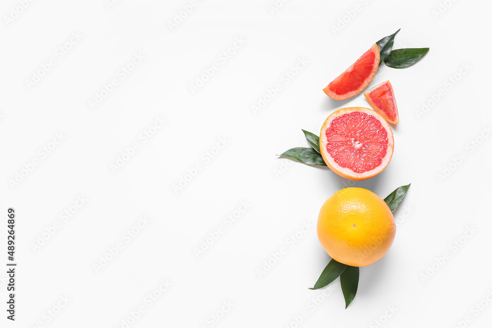 Fresh grapefruit pieces on white background